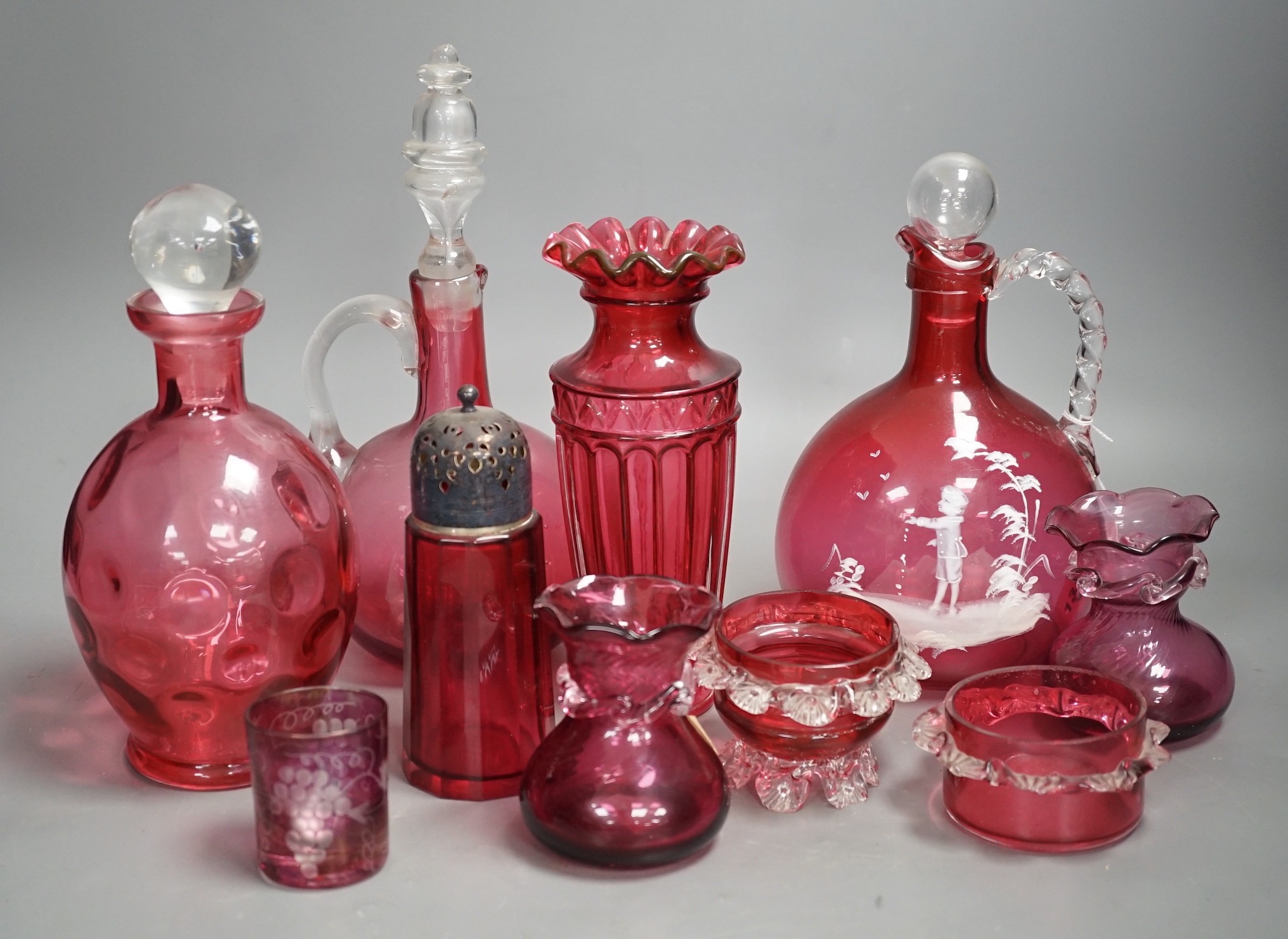 A Mary Gregory style cranberry decanter together with mixed cranberry glass (10), Mary Gregory decanter 25cms high including stopper